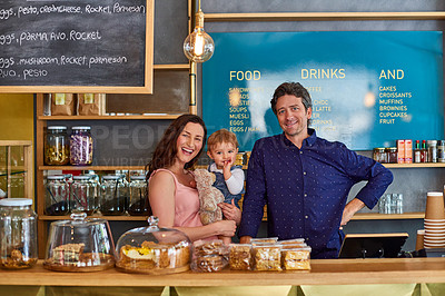 Buy stock photo Portrait of smiling couple and their little girl standing in their bakery
