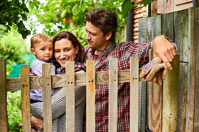 Buy stock photo Portrait of a couple with their baby girl standing their organic garden