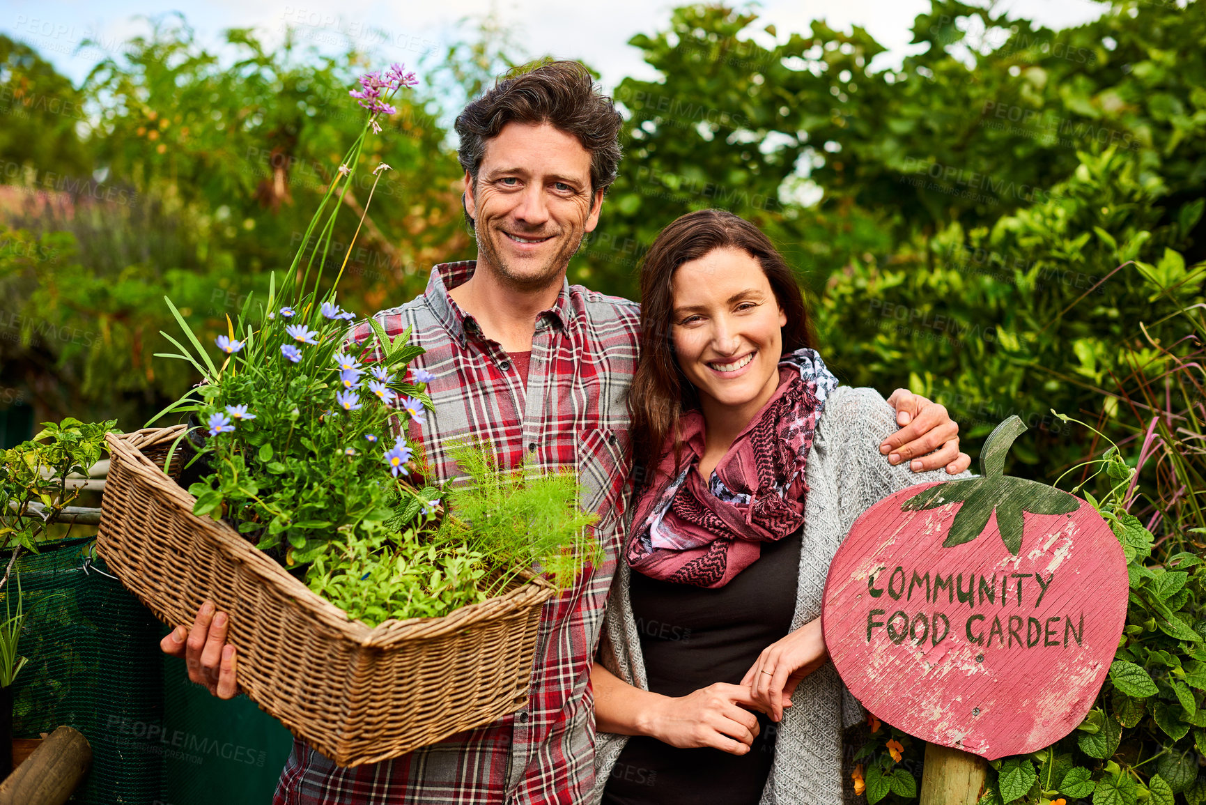 Buy stock photo Portrait, couple and harvest from community garden with sign, sustainable living and green growth. Urban agriculture, eco friendly and happy people by board for healthy food, produce and together