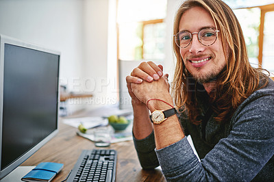 Buy stock photo Portrait of a smiling young man sitting at his desk in an office