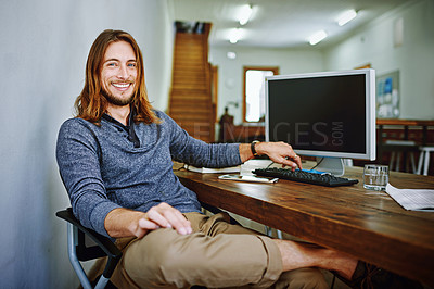 Buy stock photo Portrait of a smiling young man sitting at his desk in an office