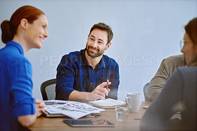 Buy stock photo Shot of a group of smiling colleagues talking together while working in an office