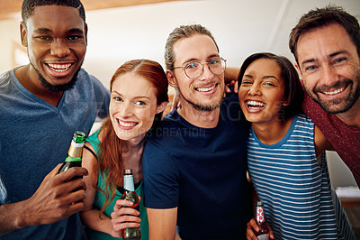 Buy stock photo Portrait of a group of colleagues talking and drinking beers together while winding down after work