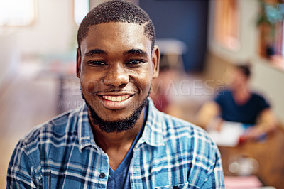 Buy stock photo Portrait of a smiling young man standing in an office with colleagues in the background