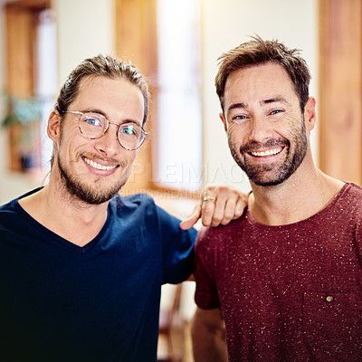 Buy stock photo Portrait of two smiling colleagues standing together in an office