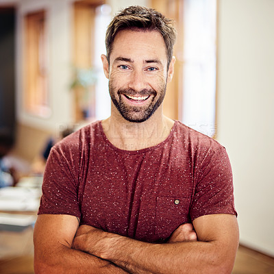 Buy stock photo Portrait of a smiling man standing with his arms crossed in an office