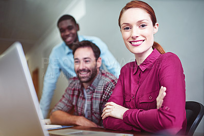 Buy stock photo Portrait of a group of businesspeople working together on a laptop in an office