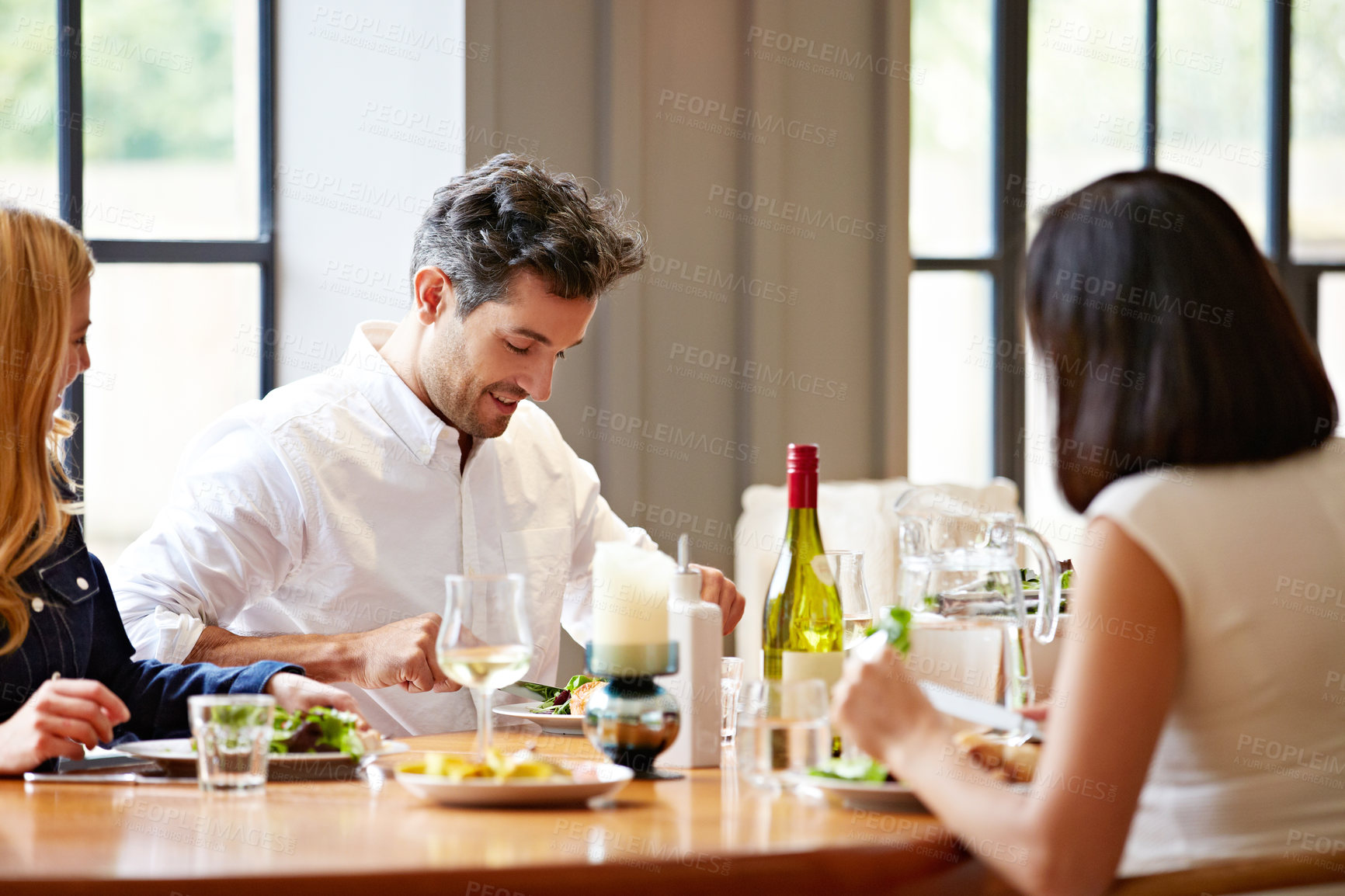 Buy stock photo Happy, eating and friends in restaurant for lunch, meal and bonding for social gathering. Food, wine and men with women for hangout, conversation and reunion for weekend, outing and dinner together