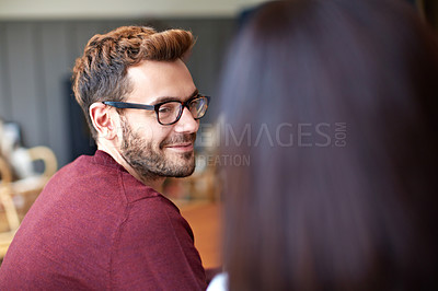 Buy stock photo Shot of a young man enjoying the conversation over dinner