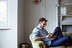 Chilling at home with his tablet