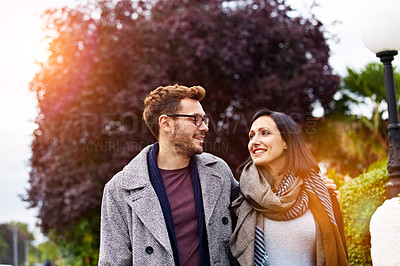 Buy stock photo Shot of a young pregnant woman and her husband enjoying a walk together