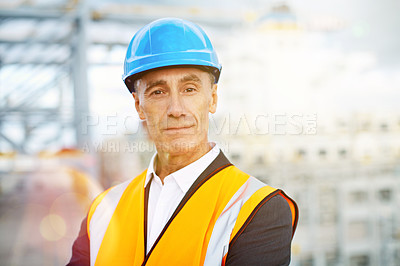 Buy stock photo Portrait of a mature man in workwear standing in a large commercial dock