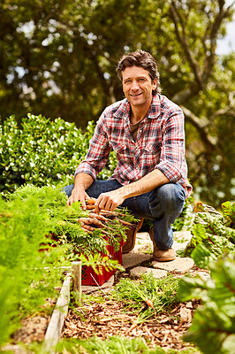 Buy stock photo Portrait of a smiling man kneeling in his organic garden