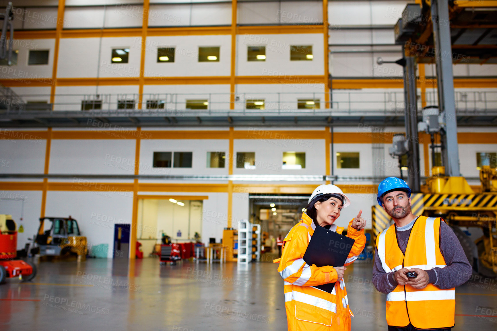 Buy stock photo People, engineer and talk at warehouse with clipboard, inspection and compliance for maintenance. Team, pointing and technician at factory with checklist report, quality control and safety evaluation
