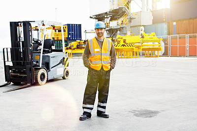 Buy stock photo Portrait of a young man in workwear standing outside on a large commercial dock