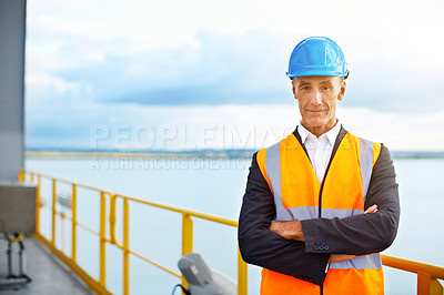 Buy stock photo Portrait of a mature man in workwear standing in a large commercial dock