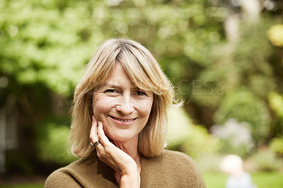 Buy stock photo Portrait of a mature woman standing outside in her yard