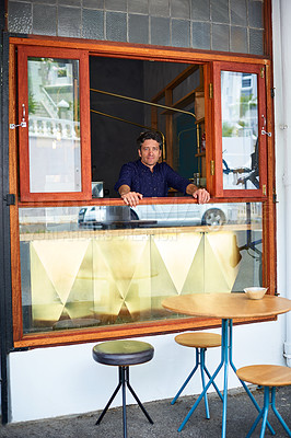 Buy stock photo Portrait of man looking through the takeaway window of his bakery cafe