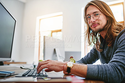 Buy stock photo Portrait of a smiling young man sitting at his desk in an office