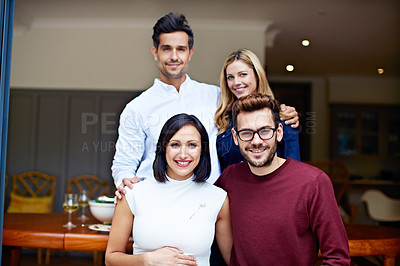 Buy stock photo Portrait of a group of young friends enjoying a get-together at home