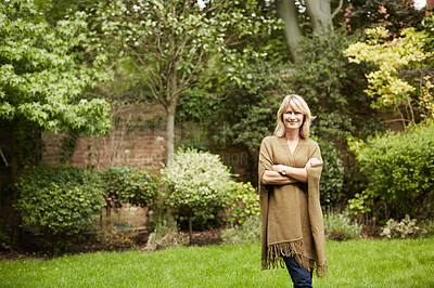 Buy stock photo Portrait of a mature woman standing outside in her yard