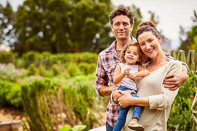 Buy stock photo Portrait of a couple with their little girl standing their organic garden