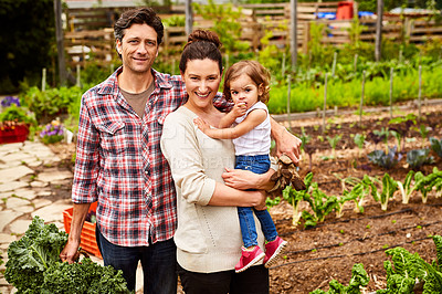 Buy stock photo Portrait of a couple with their little girl standing their organic garden