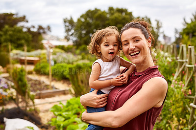 Buy stock photo Portrait of a mother with her little girl standing an organic garden