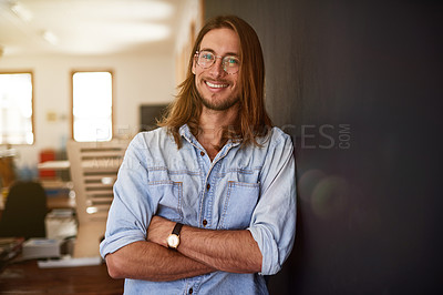 Buy stock photo Portrait of a smiling young designer standing with his arms crossed in an office