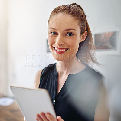 Buy stock photo Portrait of a young woman standing in an office using a digital tablet