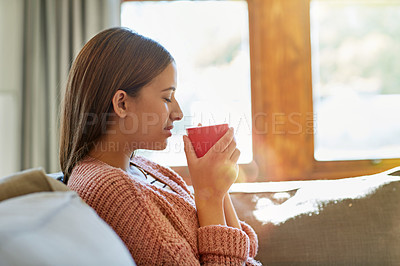 Buy stock photo Shot of a beautiful young woman smelling her freshly brewed coffee