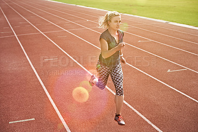 Buy stock photo Shot of a young athlete out running on the track