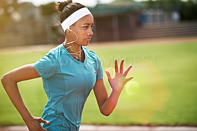 Buy stock photo Shot of a young athlete out running on the track