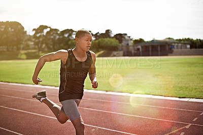Buy stock photo Shot of a young athlete out running on the track
