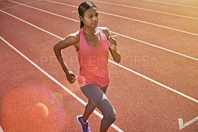 Buy stock photo Shot of a young athlete out running on the track