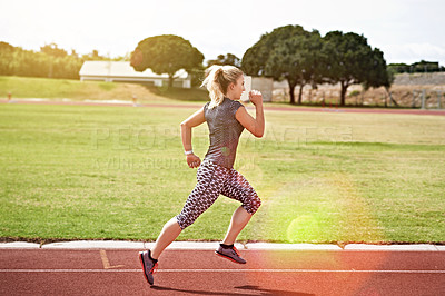 Buy stock photo Shot of a young athlete out running on the track