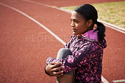 Buy stock photo Shot of a young athlete out on the track