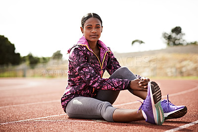 Buy stock photo Shot of a young athlete out on the track