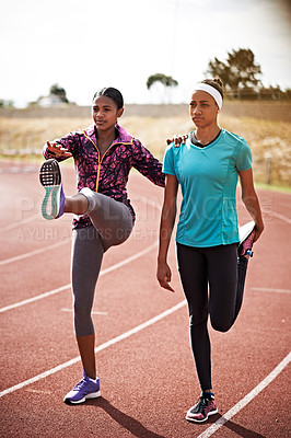 Buy stock photo Cropped shot of two young athletes out on the track