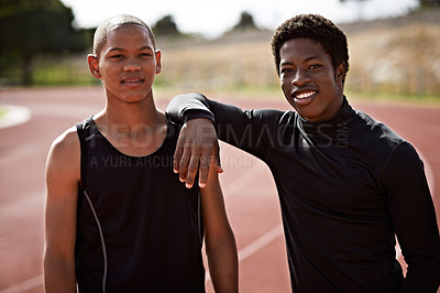 Buy stock photo Cropped shot of two young athletes out on the track
