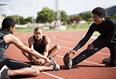 Buy stock photo Shot of young athletes sitting together on the track