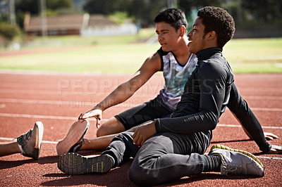 Buy stock photo Shot of young athletes sitting together on the track