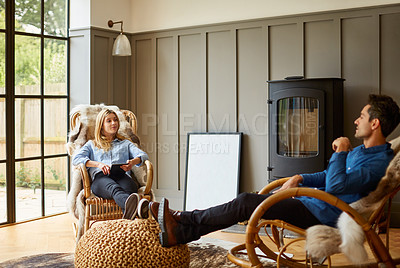 Buy stock photo Shot of a couple relaxing together on rocking chairs at home
