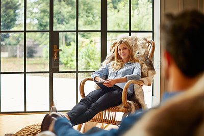 Buy stock photo Shot of a couple relaxing together on rocking chairs at home