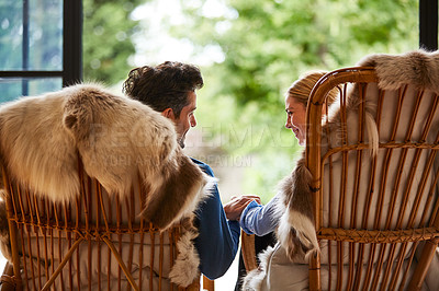 Buy stock photo Rearview shot of a couple relaxing together on rocking chairs at home