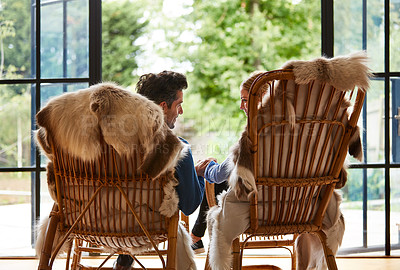 Buy stock photo Rearview shot of a couple relaxing together on rocking chairs at home