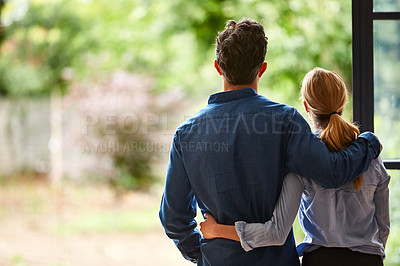 Buy stock photo Rearview shot of a couple looking at the view outdoors from their home