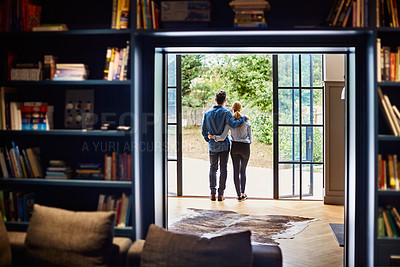 Buy stock photo Rearview shot of a couple looking at the view outdoors from their home