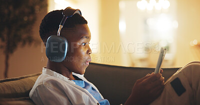 Buy stock photo Headphones, surprise and black child with tablet in home at night with educational gaming or growth. Relax, shock and boy kid with technology for game, development or hobby on app in living room.