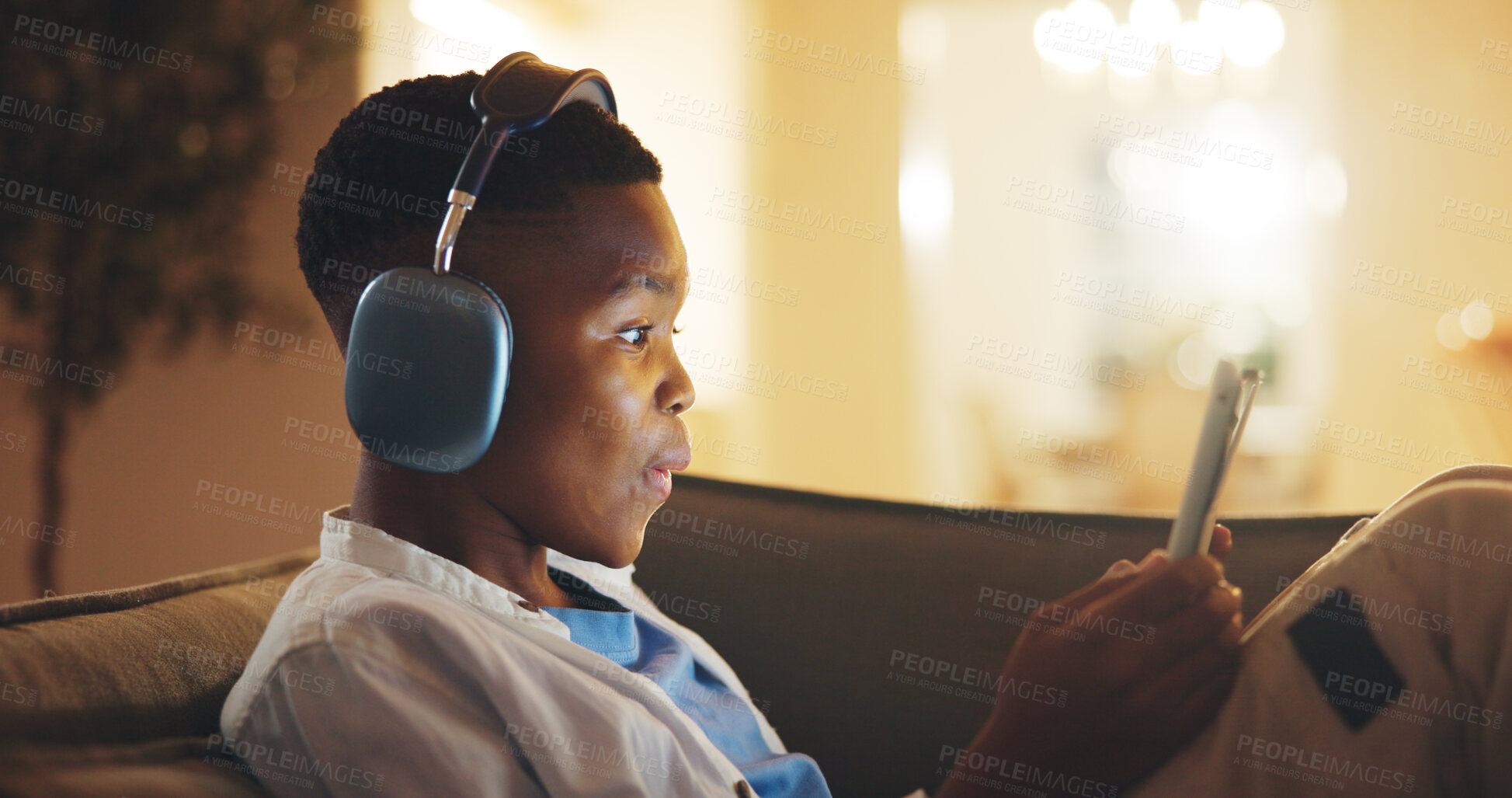 Buy stock photo Headphones, surprise and black child with tablet in home at night with educational gaming or growth. Relax, shock and boy kid with technology for game, development or hobby on app in living room.